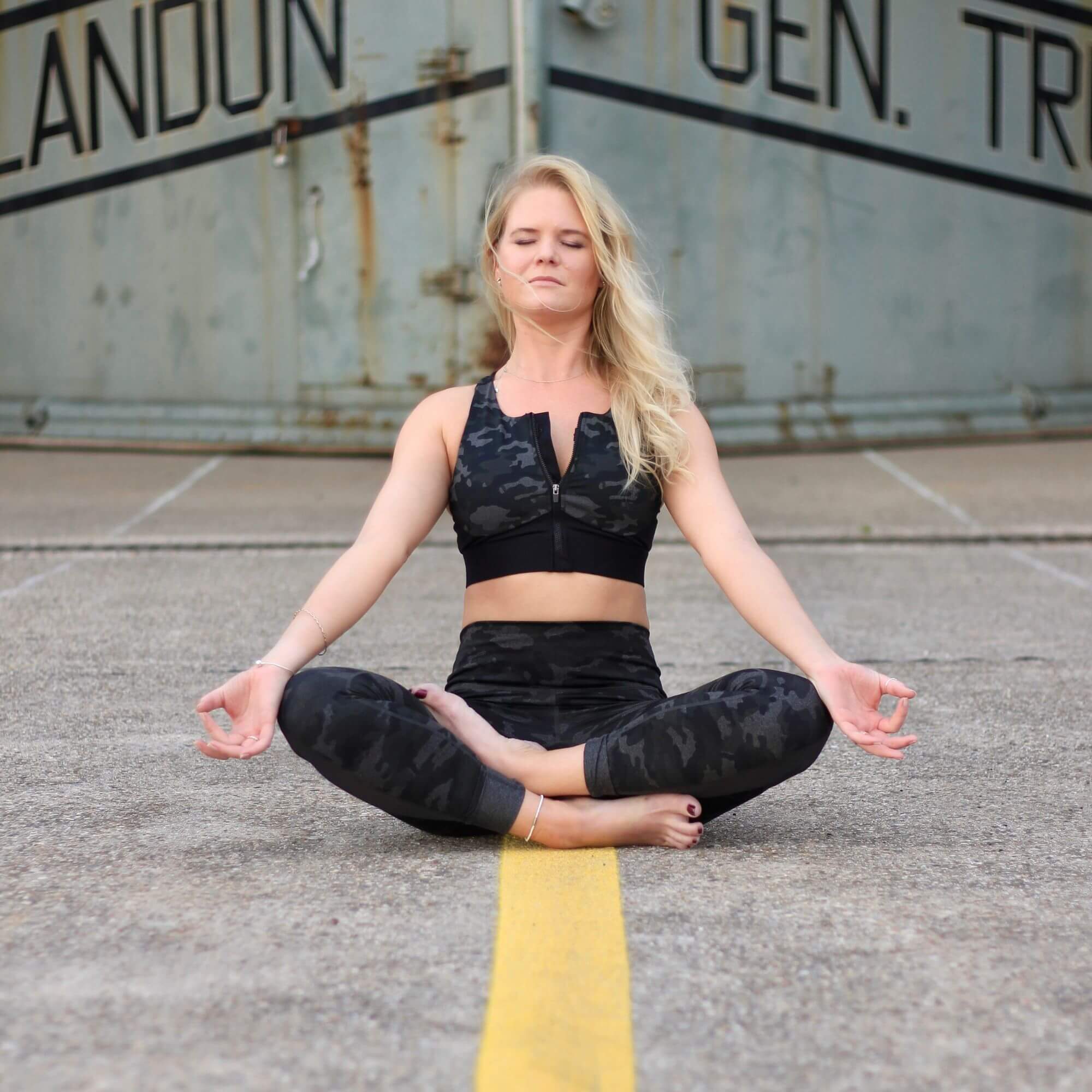 An image of Melissa Burgard in a meditative Yoga position